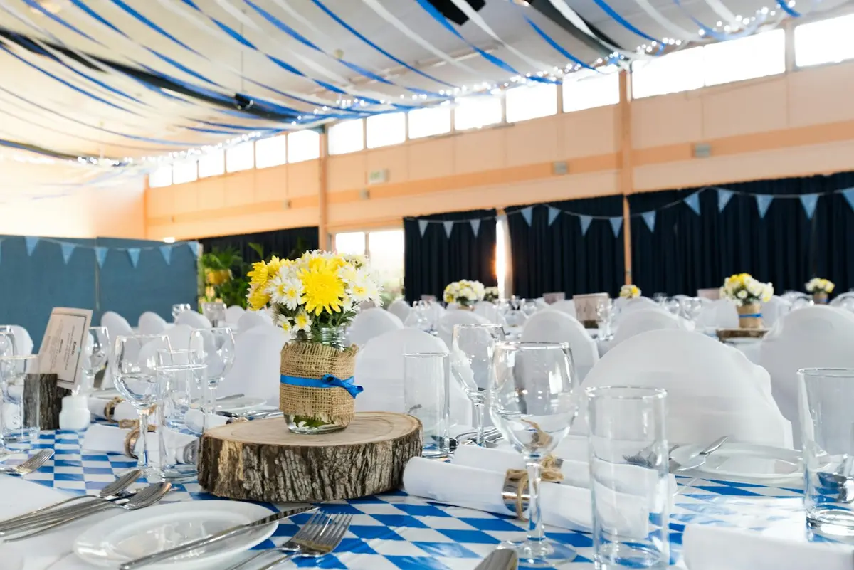 Event tables dressed with flowers and glassware