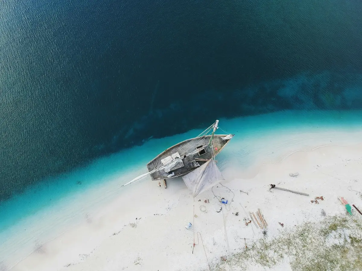 Boat over a shallow sandbank in clear turquoise water